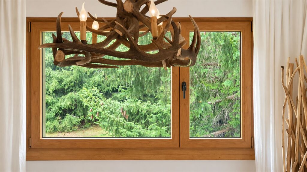 Wood-finish PVC window overlooking the forest